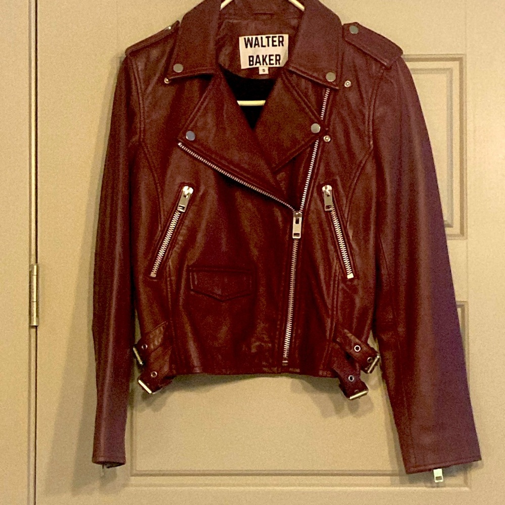 Maroon leather jacket with silver zippers and snaps